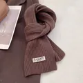Close-up of deep brown 100% Australian wool scarf showing thick ribbed knit texture - Coffee