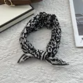 Chic black and white leopard print silk scarf styled in a knot for neck or hair accessory - 70x70cm / Leopard Black White