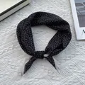Detail of black silk blend square scarf with white paisley pattern and beige border knot - 70x70cm / Small Paisley Black