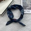 Navy blue silk square scarf with paisley pattern and star motifs in a knotted display - Bear Paisley