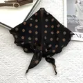 Detail of cotton neckerchief featuring a brown cross pattern with knotted styling - Black