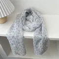 Elegant floral chiffon scarf with pleated texture in creamy white and light blue colors - Blue