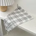 Detail of soft cotton plaid kerchief with 'Nice day' label on a minimalist background - Beige Frame Grid