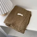 Detail view of brown crinkle cotton linen scarf with ABOUT AUTUMN fabric label - Camel