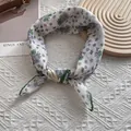 Close-up of small floral scarf with green stitched edges and Love infinity label - 58cm x 58cm / Floral Cluster