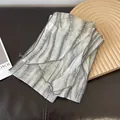 Detail showing the thin chiffon texture and gray abstract tie-dye stripes of the scarf - Off White