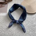 Detail of silk-texture plaid scarf with blue and green checkered pattern on white fabric - Plaid Style