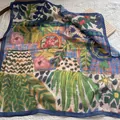 Detailed macro of vintage floral silk scarf with vibrant orange and green artistic patterns - Tree Branch