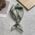 Detailed view of light green tie-dye silk scarf with gray stripes and fine hem edges - 70x70 / Green