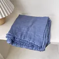 Detail of blue cotton linen scarf with elegant crochet lace edges on a white table - Denim Blue