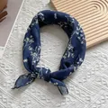 Detail of navy blue floral cotton scarf tied in a knot on a decorative wooden board - Navy Blue