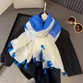 Blue and white patterned scarf with vibrant tassel fringe on black knitwear - Blue and White Tassel Style / Unique Pattern Color