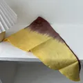 Tie-dye cotton scarf with brown and yellow gradient displayed on a white wooden table - Yellow And Coffee