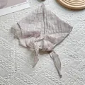 Detail of light brown plaid linen scarf with high quality fabric texture and wash label - Off White