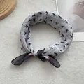 Grey cotton fashion square scarf with horse print and blue border in a lifestyle setting - 58*58cm / Gray