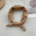 Detail of caramel paisley cotton linen scarf with elegant knot on white faux fur background - Ginger Yellow