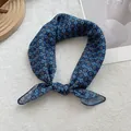 Close-up of retro floral pattern on navy blue square cotton linen scarf with fine stitching - Blue