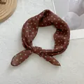 Close-up of brown French polka dot soft scarf with delicate silk-like fabric texture - Matcha Green Dot