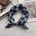 Detail of blue and grey checkered cotton neckerchief tied neatly next to a bag and magazine - 58x58cm / Black