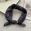 Detail of dark gray paisley bandana with leopard and floral prints on textured fabric - 58x58cm / Black
