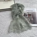 Close-up of light green lace scarf with floral embroidery and scalloped wavy edges - 140*30cm / Green