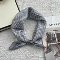 Close-up of grey and white checkered cotton neckerchief tied in a decorative knot - 58cm x 58cm / Gray