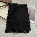 Detailed close-up of vintage black floral lace scarf with intricate embroidery texture - Black