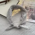 Dettaglio di una sciarpa grigio chiaro con fiori blu su sfondo bianco testurizzato - 70cmx70cm / Bianco Sporco