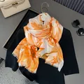 Detail of thin floral cotton scarf with orange sunflower print and raw fringe edges - 180*90CM / Daisy-Orange