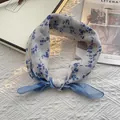 Light blue floral cotton scarf with vintage prints on textured white tablecloth - Blue