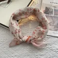Vintage floral cotton scarf in cream and orange, shown tied as a stylish neckerchief - Orange