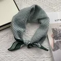 Detail of green and white striped cotton neck scarf with delicate stitched edges - Green