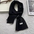 Détail d'une écharpe en lin noir avec coutures contrastées et texture minimaliste - 170x45cm / Noir