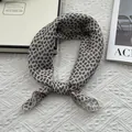 Close-up of beige paisley silk scarf tied as a necktie on a textured background - Standard Square / Off White