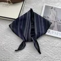 Detailed view of striped cotton neck scarf texture with minimalist knotted design - Black