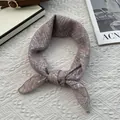 Detail of a dusty rose striped silk scarf tied in a neat knot on white knit background - 70cmx70cm / Starry Pink