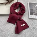 Detail of dark red linen blend scarf showing natural texture and grey stitched edges - 170x45cm / Red