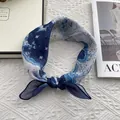 Close-up of nautical map print silk square scarf styled as a hair tie on white fabric - 58*58cm / Nautical Map Style (Dolphin Bay)