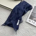 Deep blue linen skinny scarf with subtle floral print on a textured white surface - Abstract Ink Wash Floral