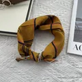 Detail of mustard yellow checkered cotton scarf with white piping on a knit background - Yellow Plaid