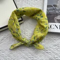 Detailed shot of yellow floral cotton scarf knotted for styling on magazine - Lemon Yellow Print