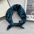 Detailed view of floral cotton linen neckerchief with leaf patterns and elegant knot - Lake Blue Leaves