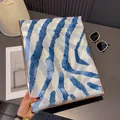 Detail of blue zebra print cotton shawl with fringe edges and soft gradient texture - Blue