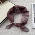 Macro detail of burgundy paisley cotton linen scarf with white polka dots and stars - Coffee