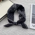 Macro detail of breathable cotton-linen scarf with black and white paisley and dot patterns - Black