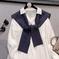 Close-up of classic cable-knit navy blue shawl paired with white collared shirt - Black