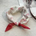 Detailed view of floral cotton neckerchief featuring pink roses and dark red hemmed edges - 58*58cm / Red
