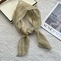 Detail of breathable yellow striped linen scarf on a minimalist white textured background - Yellow Plaid