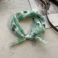 Detailed close-up of soft green floral cotton bandana with clover pattern for women - 58*58cm / Clover