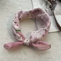 Detailed view of floral cotton linen headscarf with pink flower pattern and bow tie design - Pink